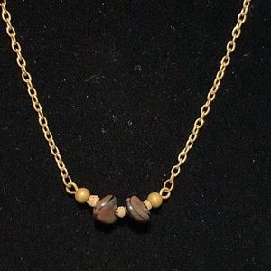 Necklace with two stones, may be petrified wood, unknown stones.